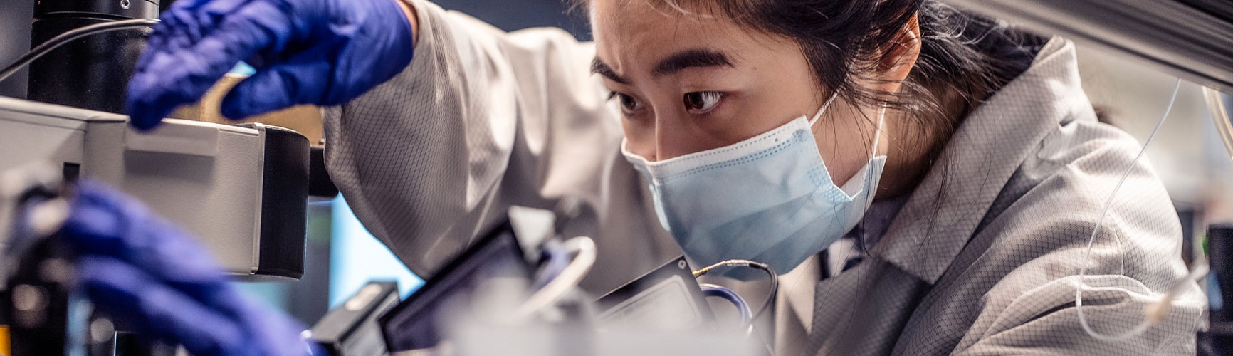 A research wearing protective equipment work in a lab at the Allen Institute